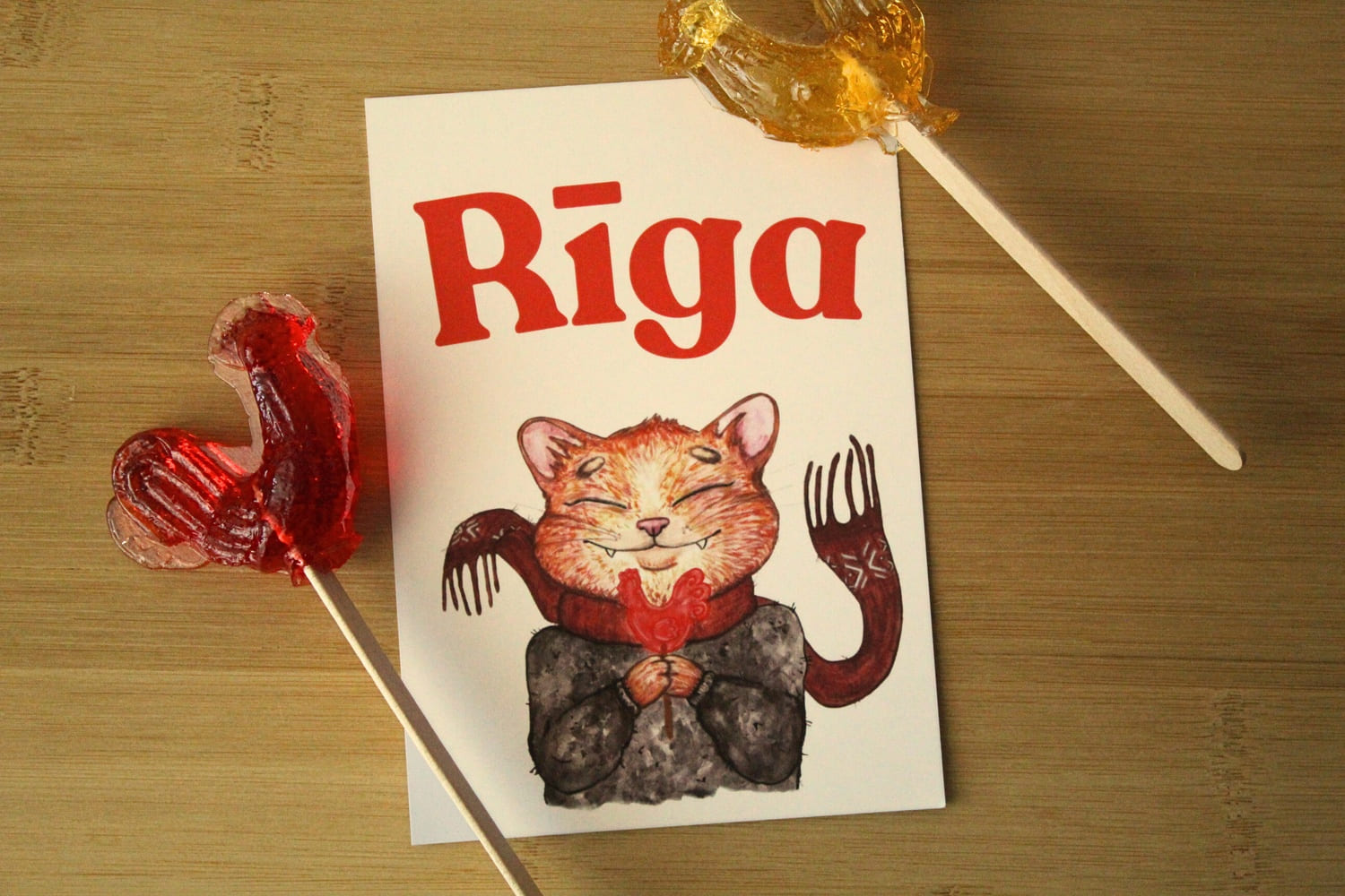 Postcard Rīga – illustrated cat with lollipop